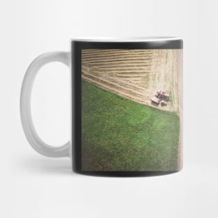 Aerial view of combine-harvester and tractor working in the field Mug